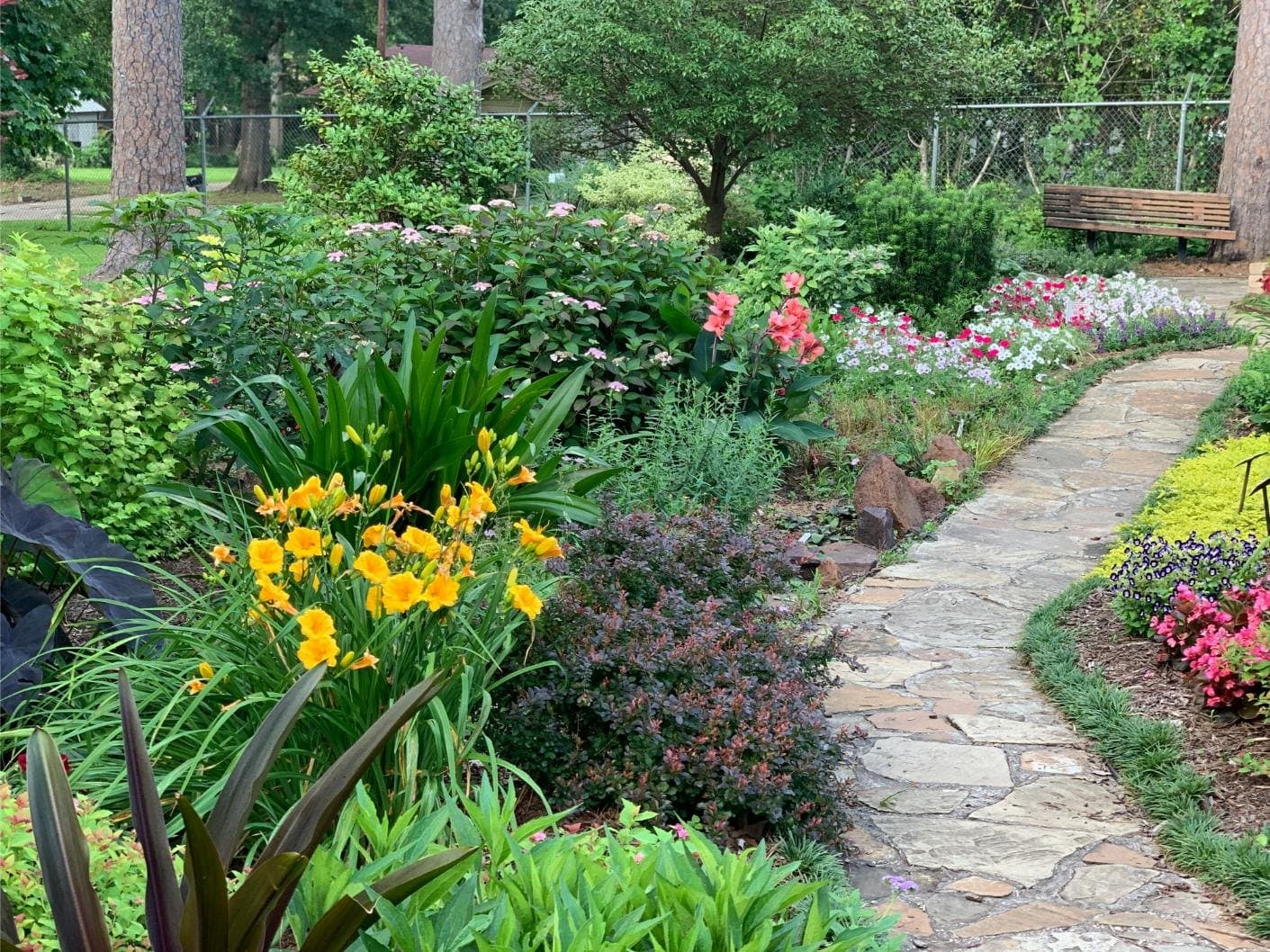 Flower beds and a stone path through a landscaped garden